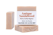 Two bars of soap with a label on a white background, featuring the brand 'Antique Sandalwood'.