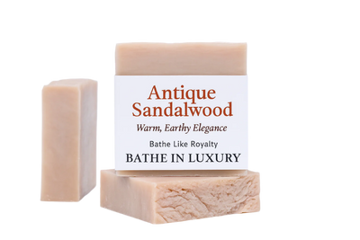 Two bars of soap with a label on a white background, featuring the brand 'Antique Sandalwood'.