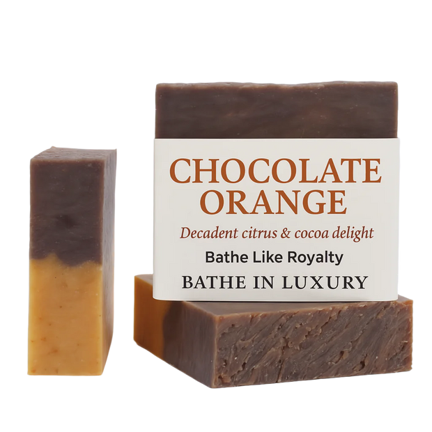 Two bars of chocolate orange soap with a descriptive label on a white background