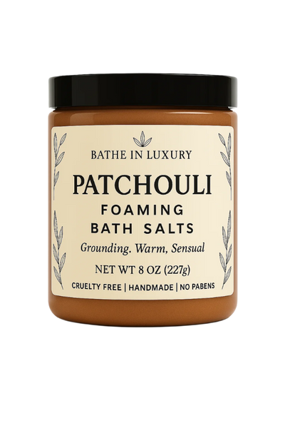 Jar of patchouli foaming bath salts with a black lid on a white background