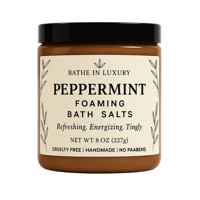 Jar of peppermint foaming bath salts with a black lid on a white background