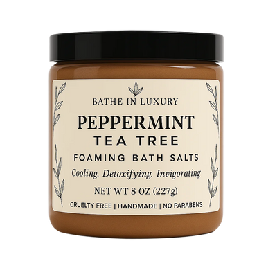 Jar of peppermint tea tree foaming bath salts with a black lid on a white background