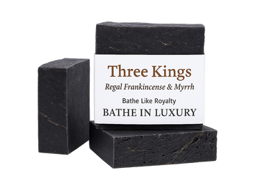 Two black soap bars with a 'Three Kings' label on a white background